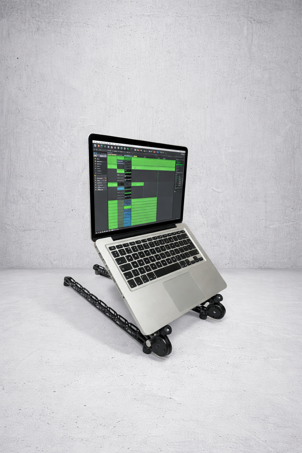 Low-profile Manofold desktop producer stand for music production, adjustable angle without wasting desk space.