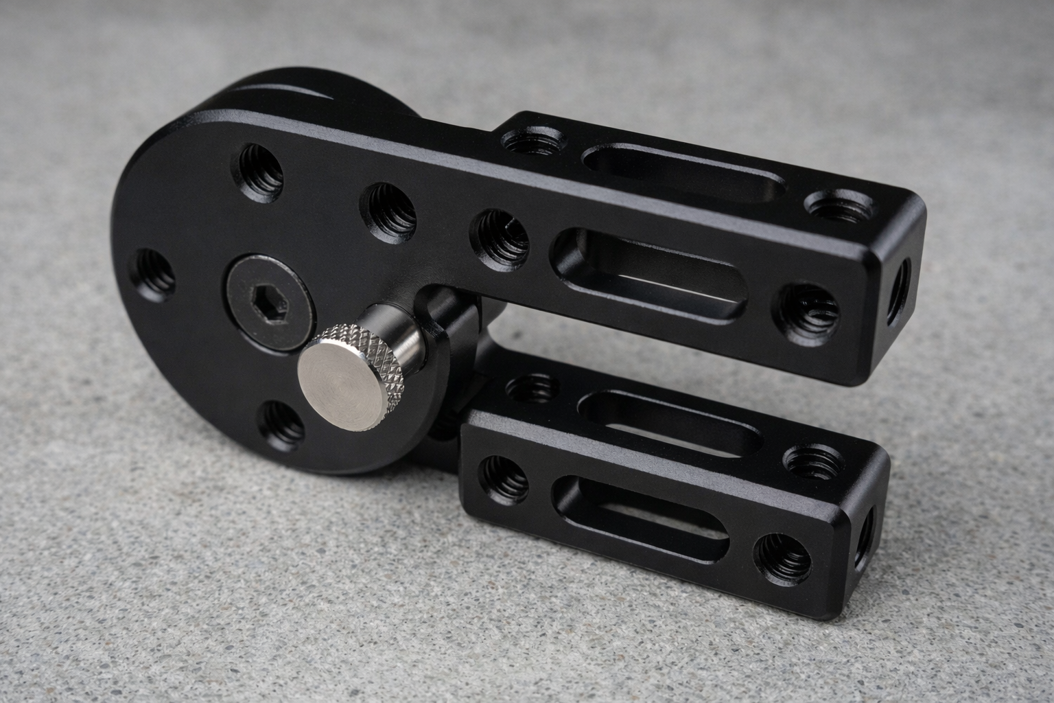 Black metal mechanical component on a gray surface