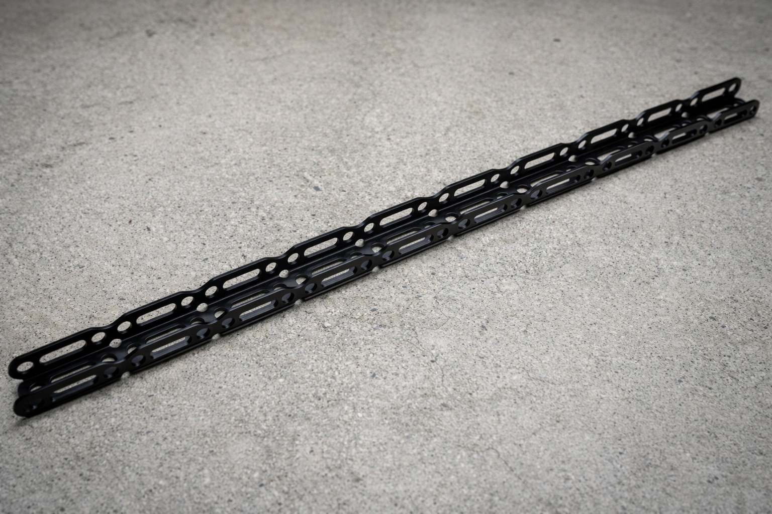 Black metal channel on a gray concrete floor