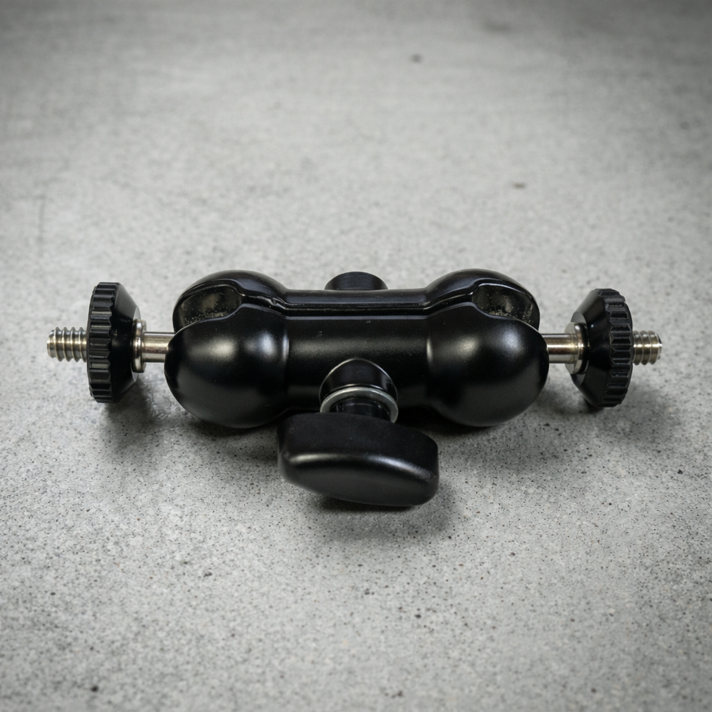 Black metal camera accessory on a gray surface