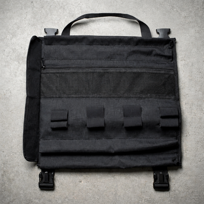 Black rollbag on a gray concrete surface