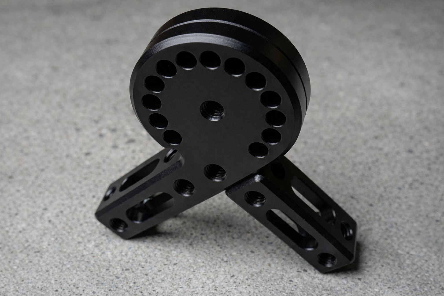 Black metal mechanical component on a gray surface