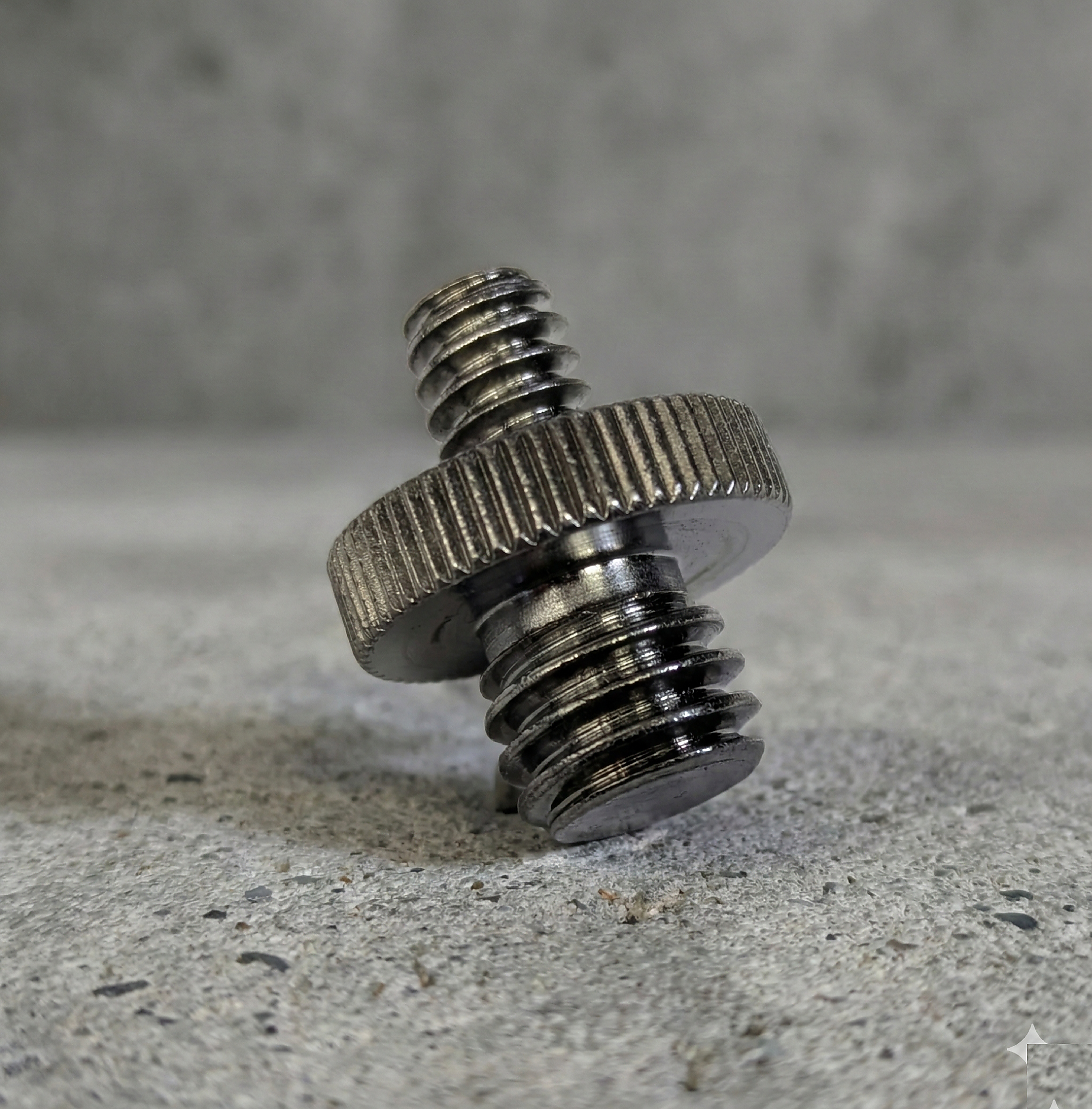 Metal screw on a concrete surface with a blurred background