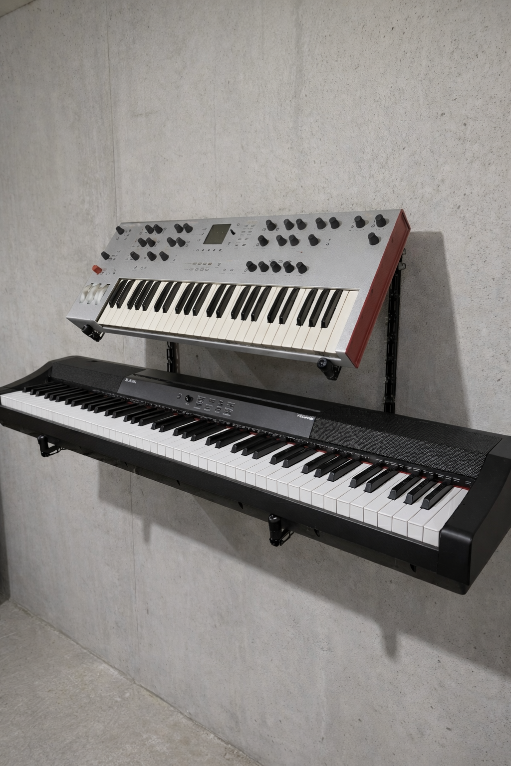 Heavy-duty Manofold desktop synth stand supporting a large analog synthesizer at an adjustable angle.